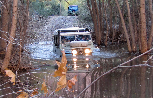 Land Rover Dormobile wading a bever pond